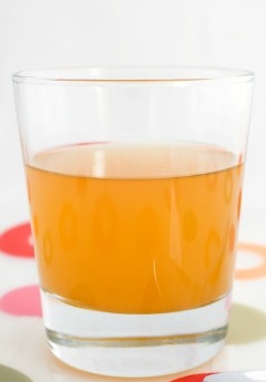 A glass of raw unfiltered apple cider vinegar with "mother".